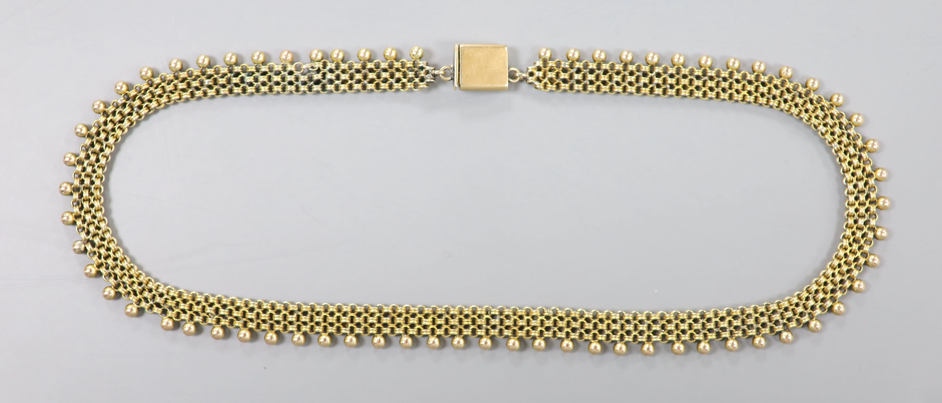 An early 20th century yellow metal fancy link and bead choker necklace, 42cm